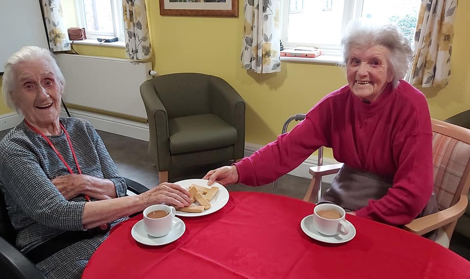 Residents enjoying tea and biscuits together
